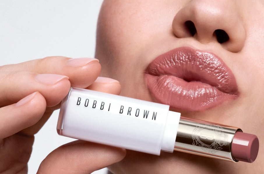 Close up of model eye showcasing defined brows and a natural, shimmery eye look